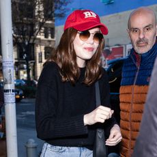 Emma Stone wearing a red baseball cap