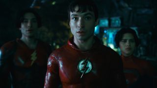 The two Barry Allens and Supergirl look at someone off camera in The Flash movie