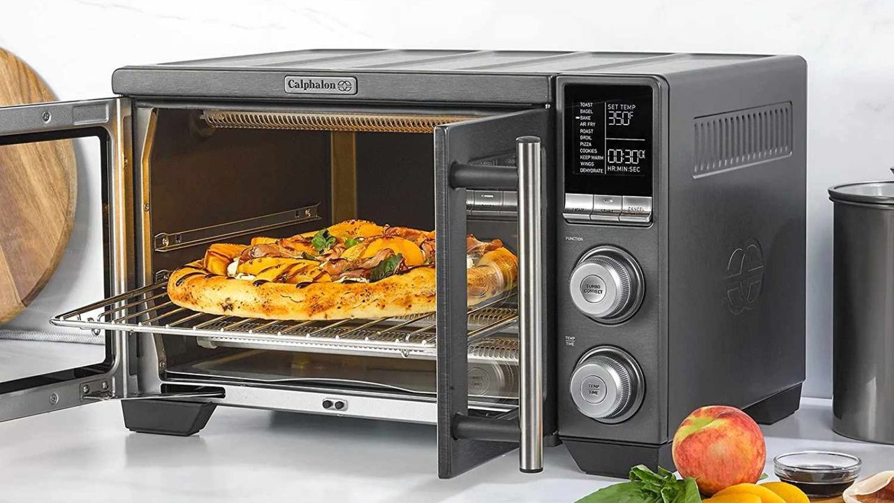 A French door air fryer cooking a pizza on a kitchen counter. 