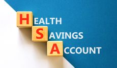HSA health saving account symbol. Concept words HSA health saving account on beautiful wooden cubes. Beautiful white blue background. Medical HSA health saving account concept. Copy space.