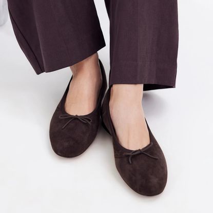 Model wearing Brown suede mango flats with brown pants