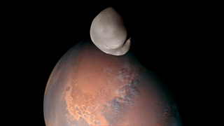 a picture of mars with a potato-shaped moon in front of it