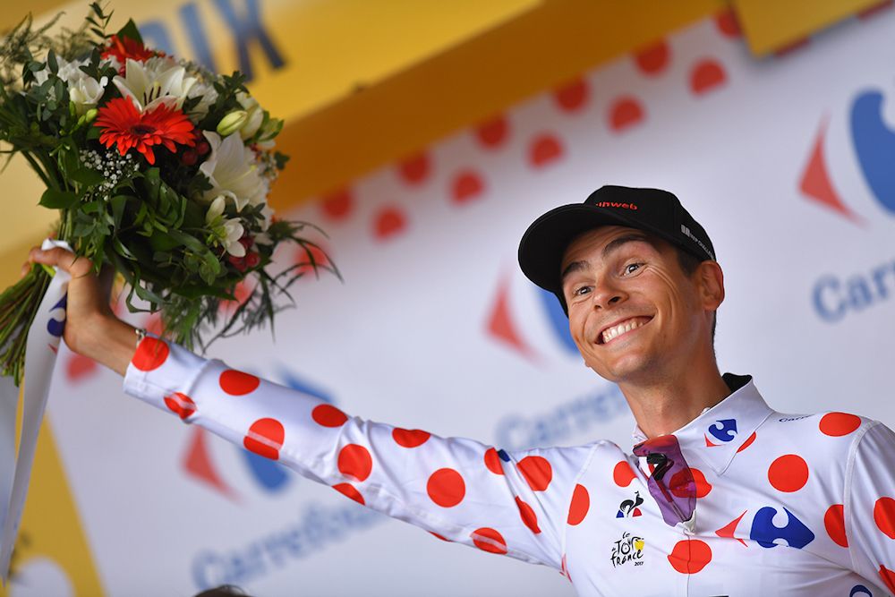 Warren Barguil on the Tour de France podium after winning stage 13 on Bastille Day.