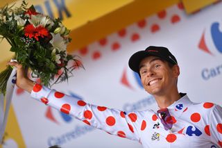 Warren Barguil on the Tour de France podium after winning stage 13 on Bastille Day.