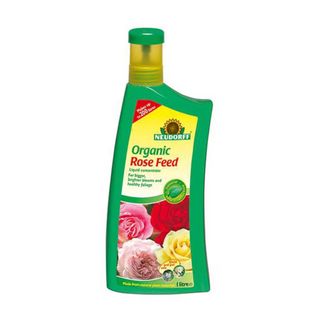 Green bottle of Neudorff organic rose feed with a a yellow label and a yellow lid