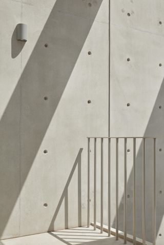 concrete walls, cast with shadows from the exterior façade