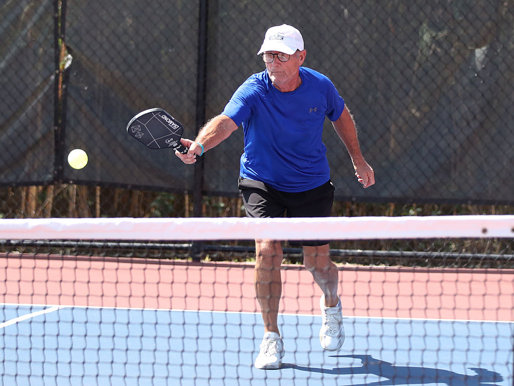 A pickleball player hits a backhand drop shot during the 2025 US Open Pickleball Championships