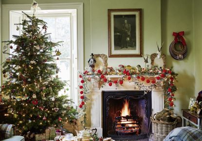 Christmas tree and lit fire in Cumbrian farmhouse
