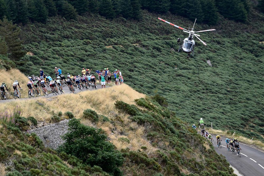 A helicopter flies above the peloton during stage 15.