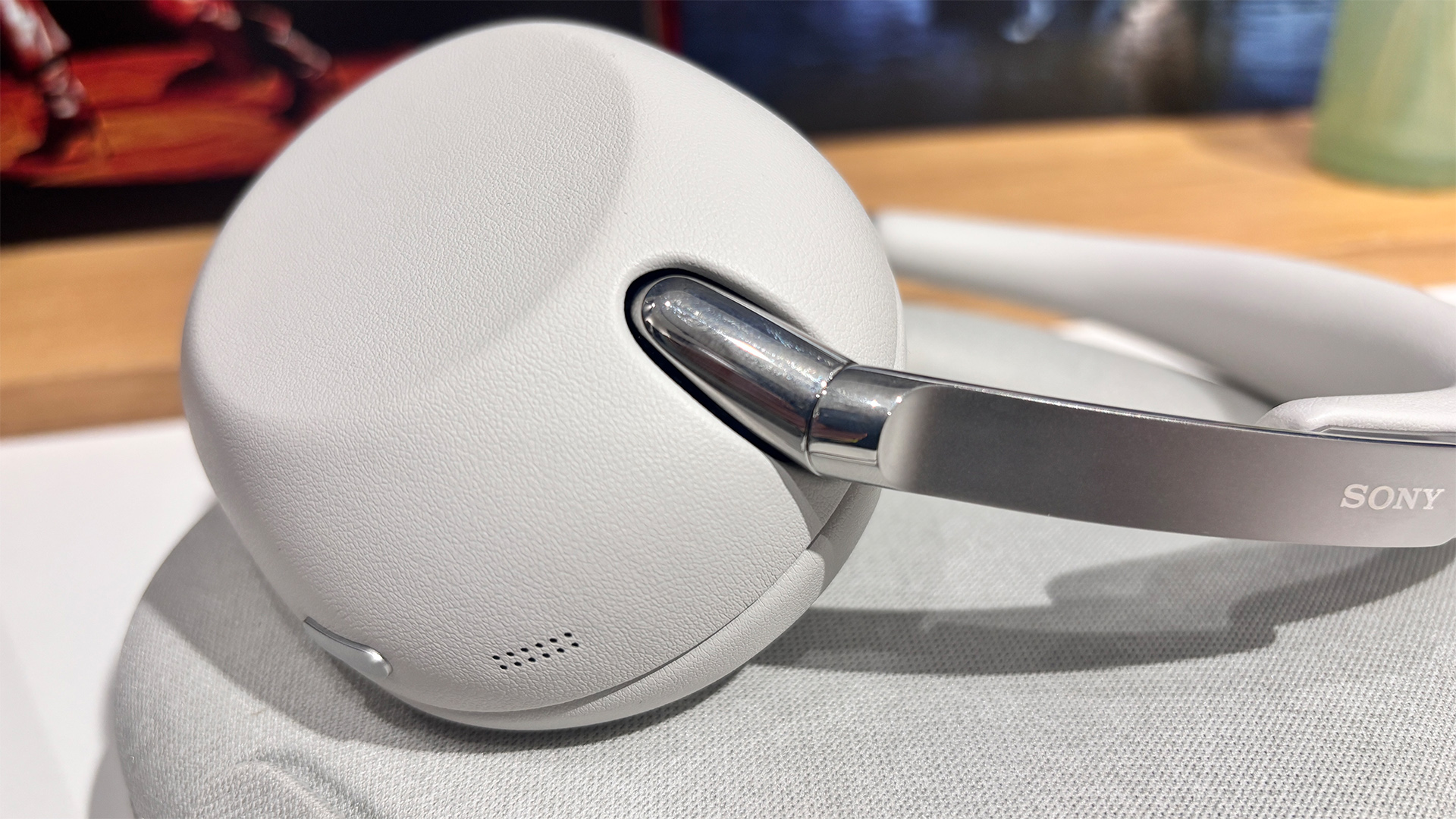 Sony 1000X The Collexion wireless headphones on white surface with focus on one earcup