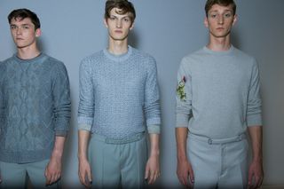 Three male models wearing clothing by Pringle of Scotland in light shades.