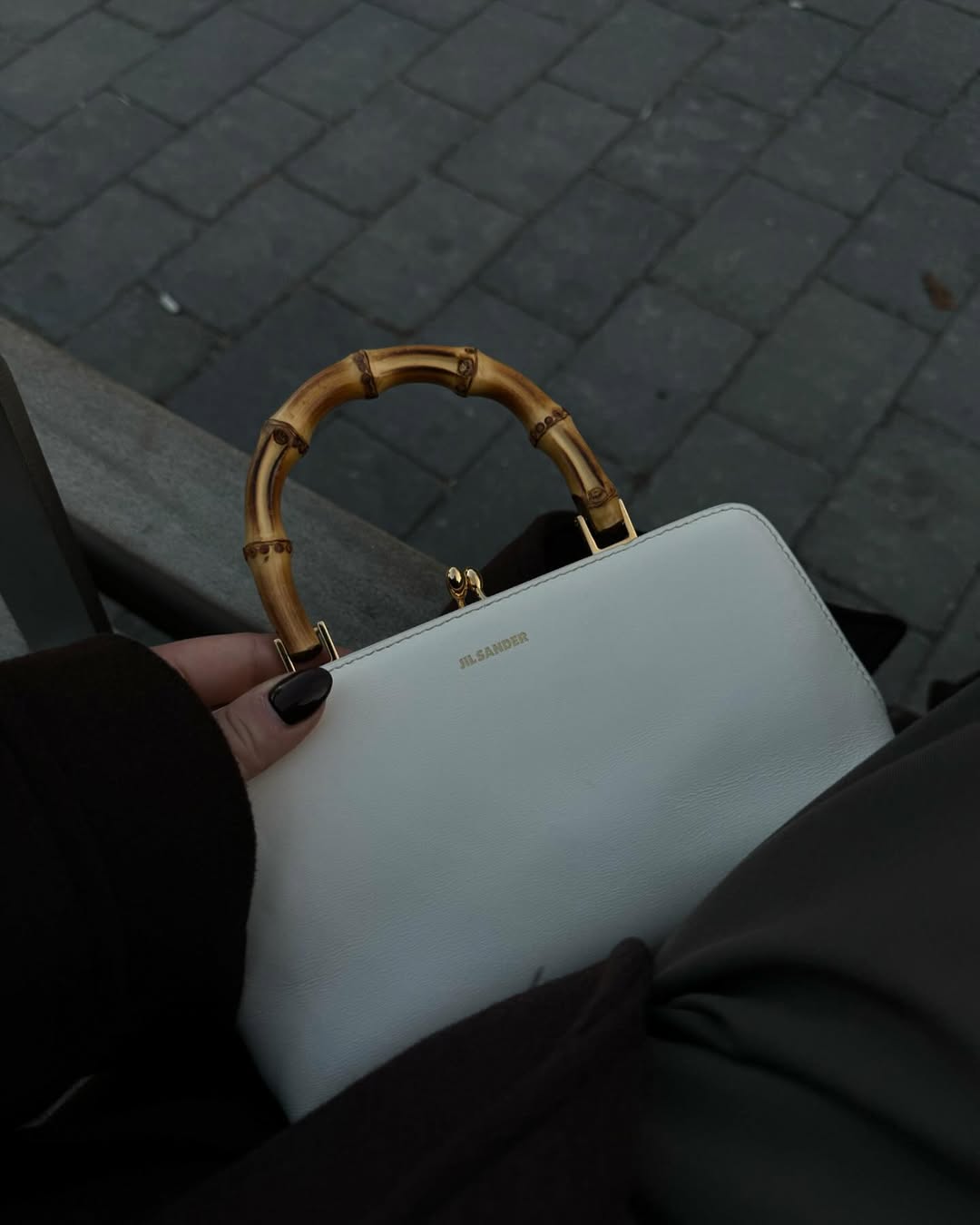 @rebeccarhysevans carries a Jil Sander top-handle bag