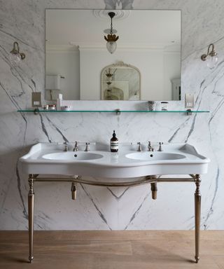 double vanity in bathroom with marble wall tiles