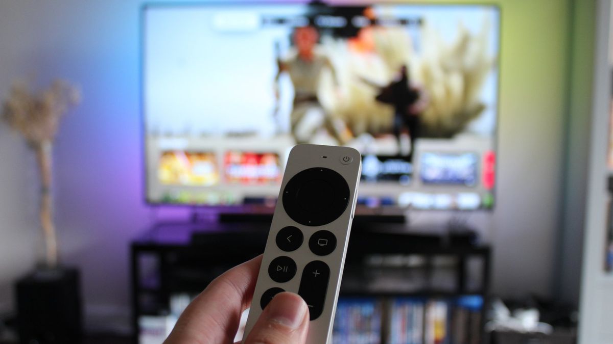 Apple Tv remote in front of a TV