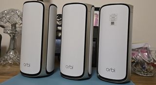 Three Netgear Orbi 970 mesh Wi-Fi modules