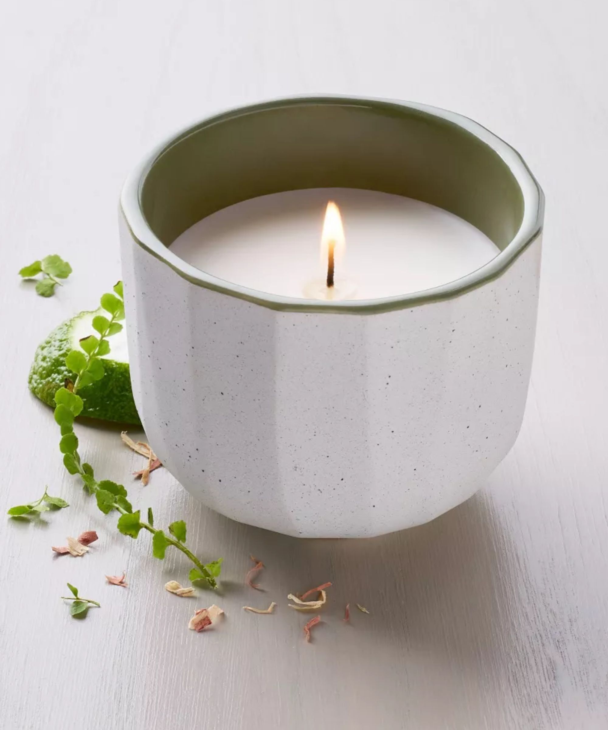 White ribbed candle holder with green interior