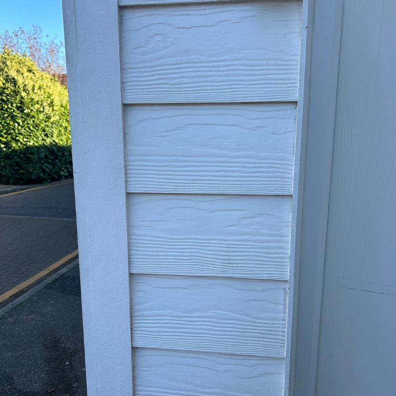 Pressure washer cleaning white cladding - after