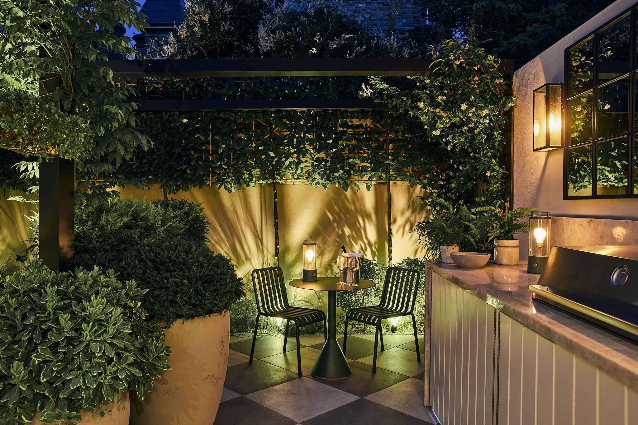 a modern garden filled with plants with a large checkerboard floor