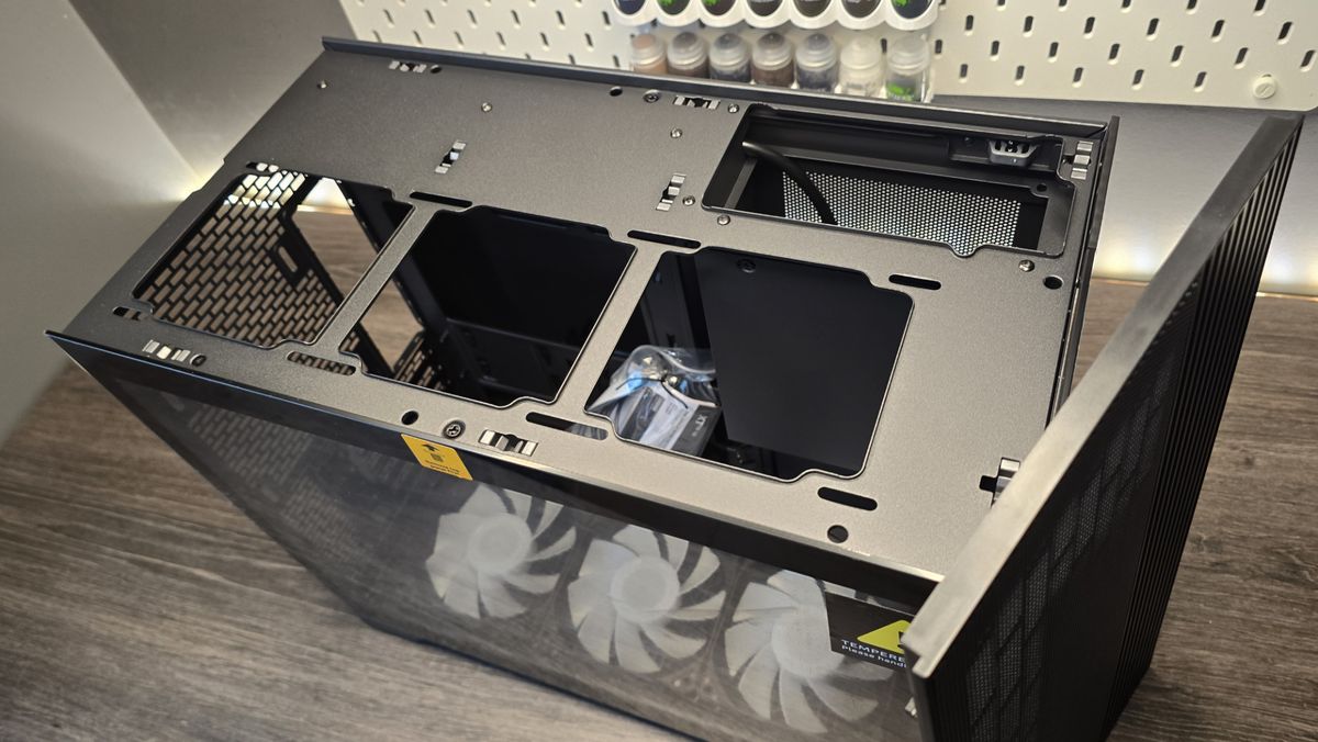 A Phanteks XT V3 PC case on a desk with various PC parts.