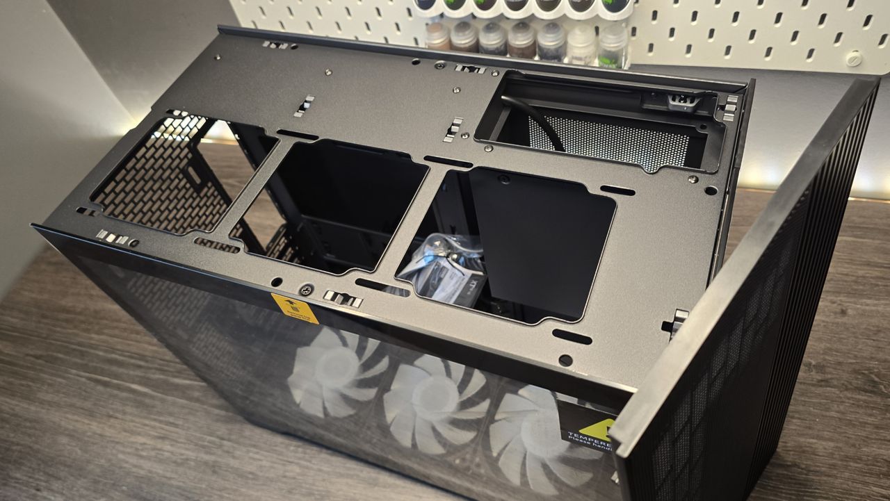 A Phanteks XT V3 PC case on a desk with various PC parts.