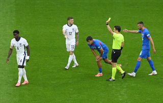 Referee Umut Meler shows a yellow card to Marc Guehi of England (L) during the UEFA EURO 2024 round of 16 match between England and Slovakia at Arena AufSchalke on June 30, 2024 in Gelsenkirchen, Germany. (Photo by Shaun Botterill/Getty Images)