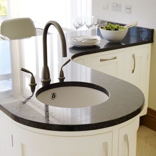 kitchen with peninsula sink and tap