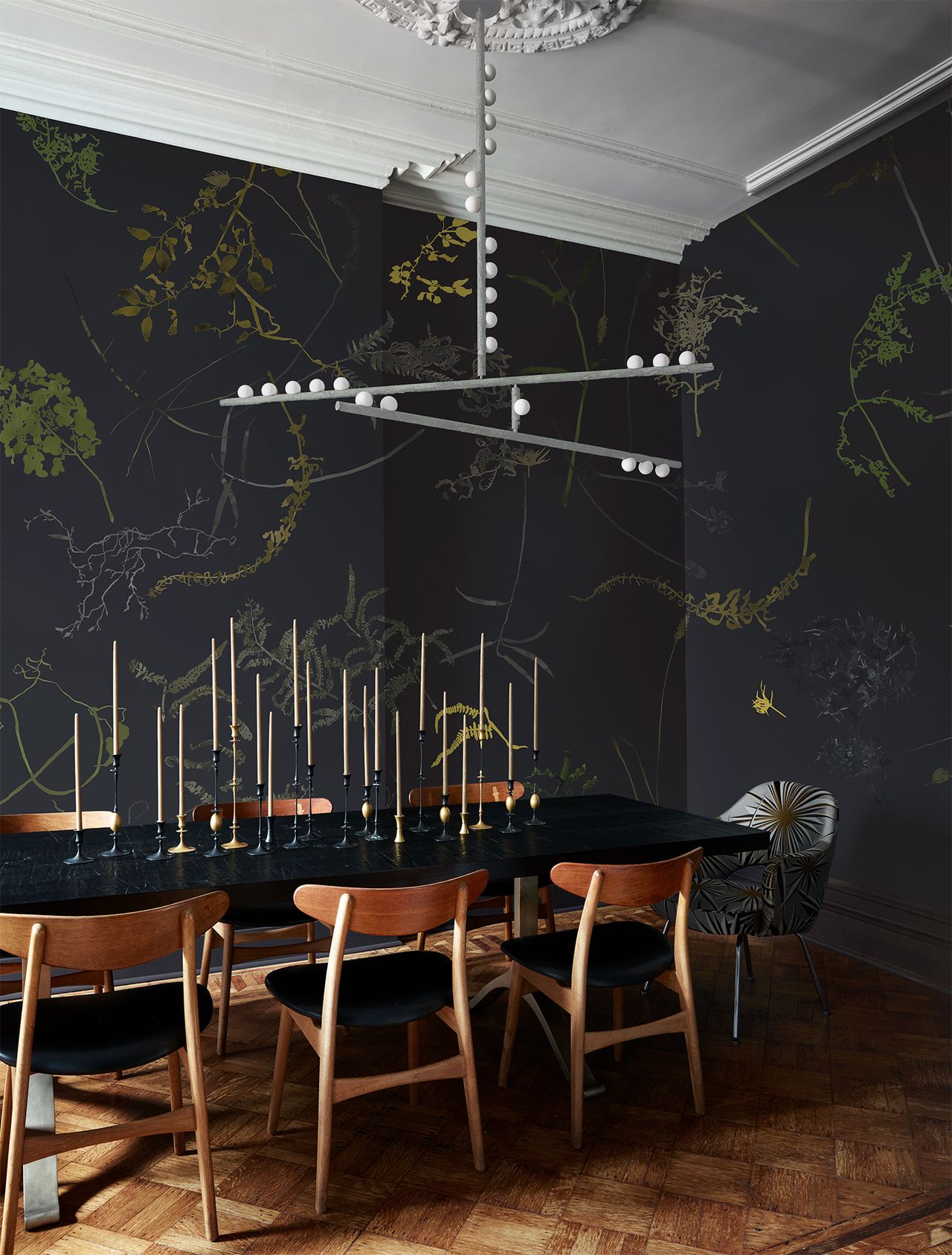A dining room with a pendant light above the table
