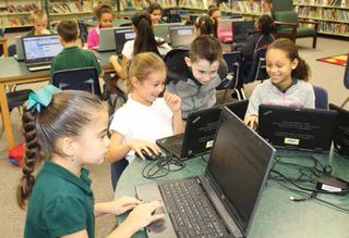 Students at Essrig Elementary in Hillsborough County SD work on digital projects in the library media center.