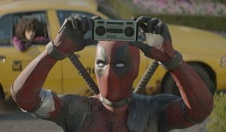 Deadpool 2 Deadpool plays music on his phone, in front of his cab