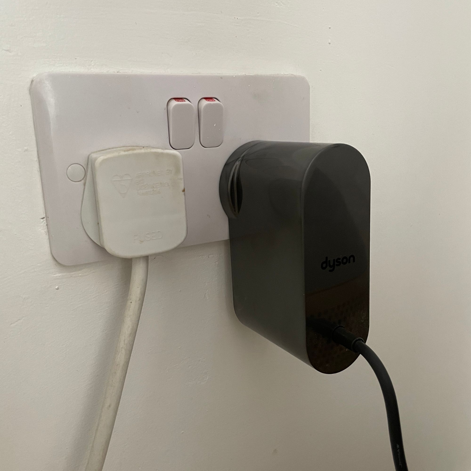 Large plug of the Dyson Purifier Humidify+Cool PH2 De-Nox next to a normal sized plug