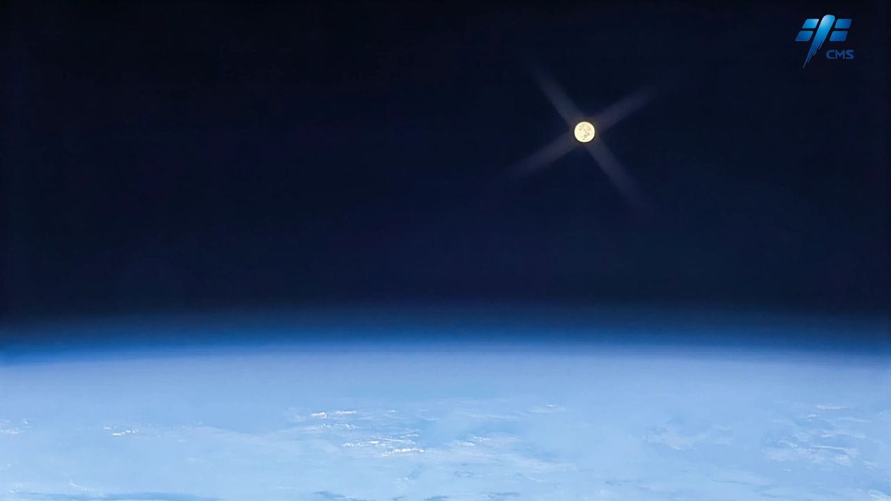 A full, distant moon imaged above Earth, taken by Liu Yang.