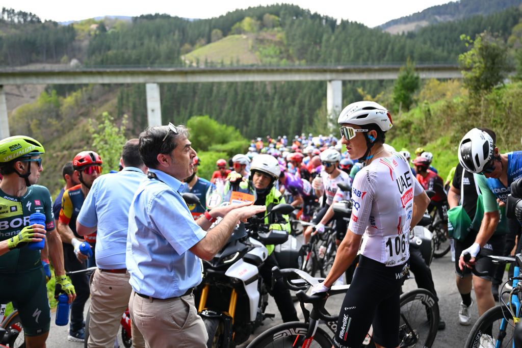 LEGUTIO SPAIN APRIL 04 LR UCI commissaire Marc Soler of Spain and UAE Team Emirates and a general view of the peloton waiting at Olaeta 582m after the neutralisation of the race due to a multiple crash during the 63rd Itzulia Basque Country 2024 Stage 4 a 1575km stage from Etxarri Aranatz to Legutio 550m Race neutralised due to a multiple riders crash and dropouts The breakaway will dispute the victory UCIWT on April 04 2024 in Etxarri Legutio Spain Photo by Tim de WaeleGetty Images