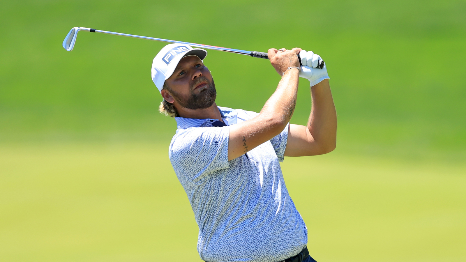 Daniel Brown hits an iron shot into the green