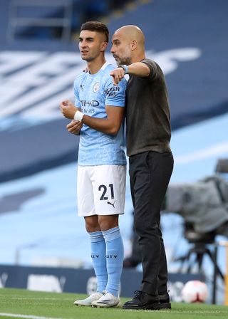 Pep Guardiola (right) has no plans to replace Torres in the City squad with a specialist striker