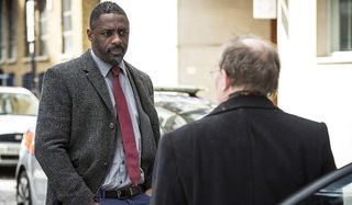 Luther Idris Elba questioning someone in an alley