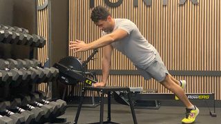 James Shapiro performing an incline push-up with bird-dog reach