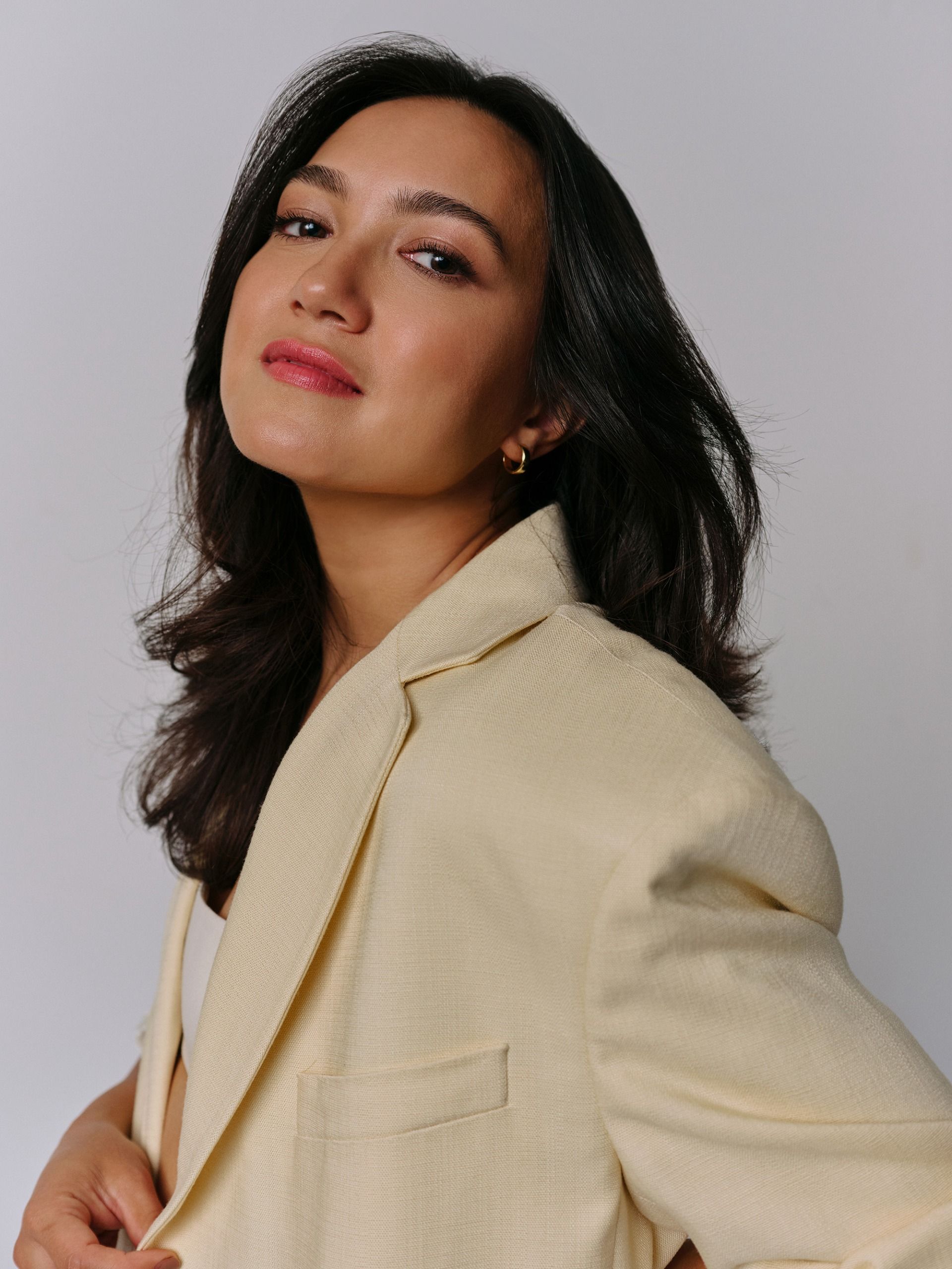Rachel Marsh wearing a butter yellow suit with a white bralette.