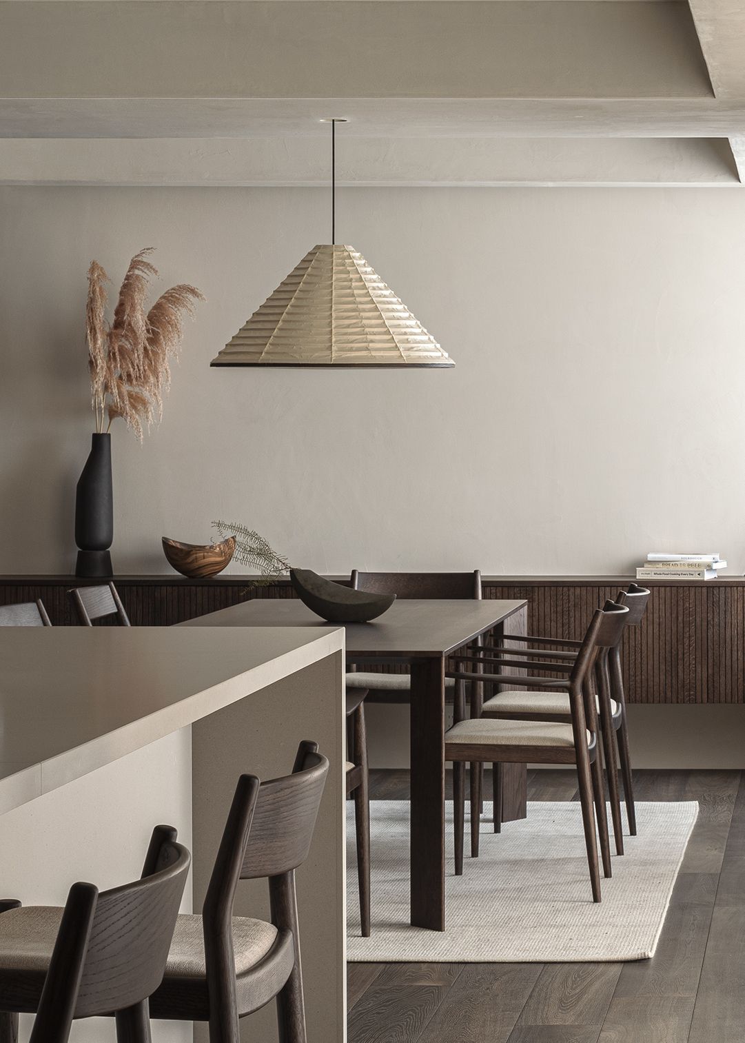 A minimalistic space with sleek furniture, lighting and a muted color palette