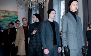 A range of models featuring the more relaxed silhouettes that paired relaxed turtlenecks under tailored blazers, combined with long tweed coats, often worn closed with a knotted waist tie.