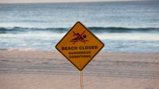 Sign that says beach closure.