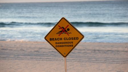 Sign that says beach closure.