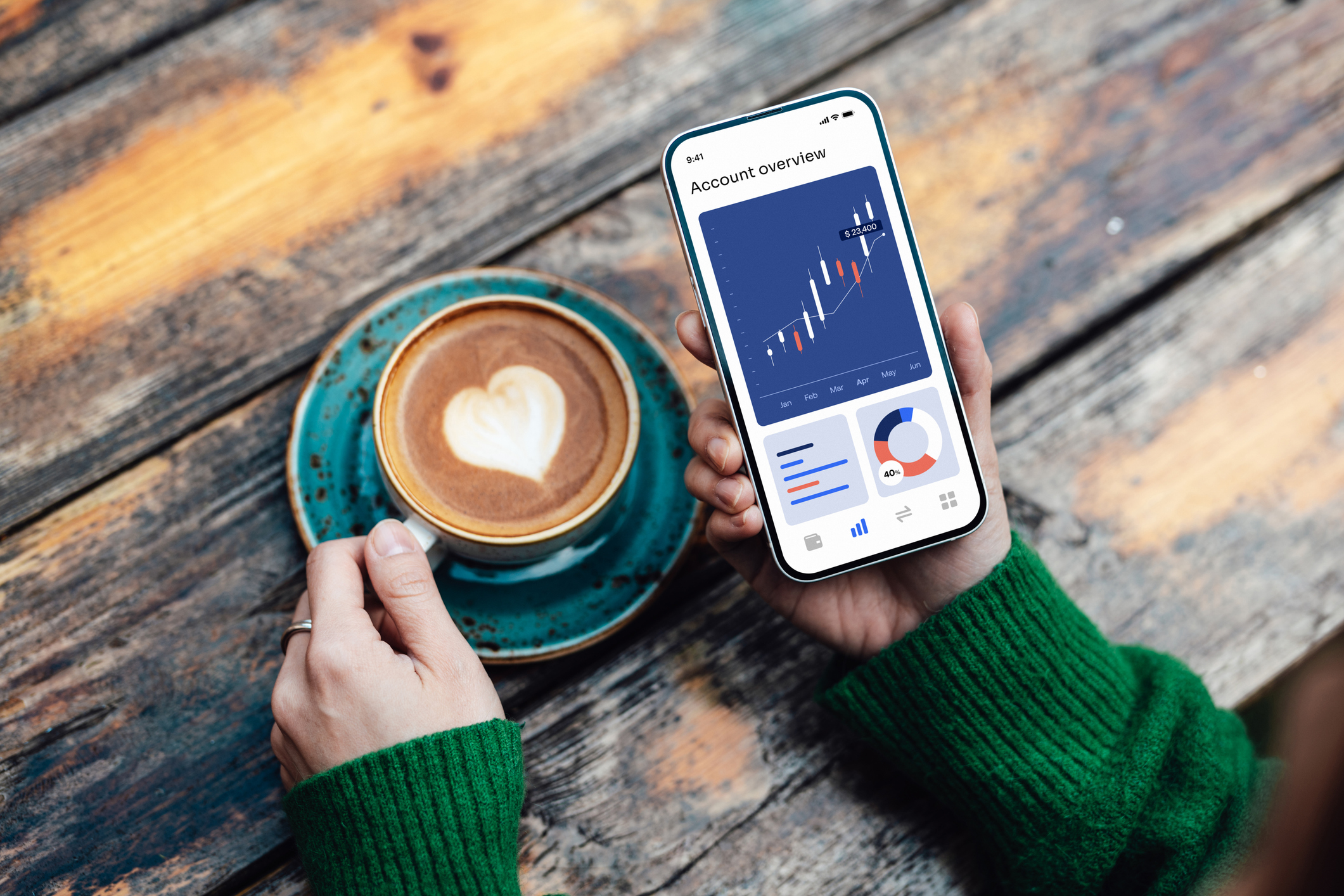 Person looking at their investments while drinking cofee