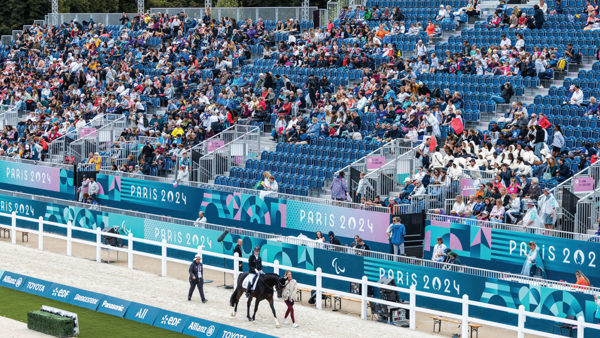 Pictured a horse and para dressage rider walking round the arena at the Paris Paralympic Games in 2024.
