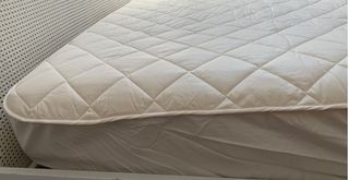 Bed with Woolroom Deluxe Washable Mattress protector on the mattress