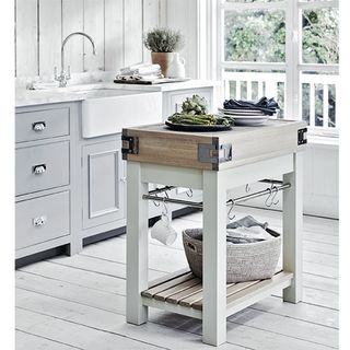 white kitchen with white wooden flooring and drawers