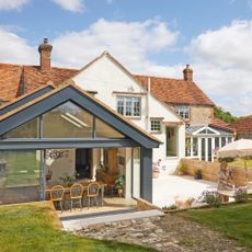 exterior of period property with modern glazed extension and patio area