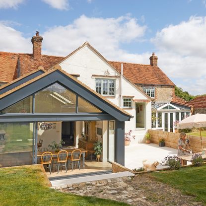 exterior of period property with modern glazed extension and patio area