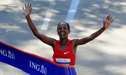 Firehiwot Dado of Ethiopia celebrates as she wins the Women's Division of the 42nd ING New York City Marathon in 2011: Critics say the Sandy-ravaged city ought to cancel this year's race.
