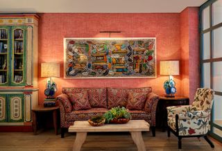 A vibrantly designed hotel lobby features eye-catching textiles and painted furniture.