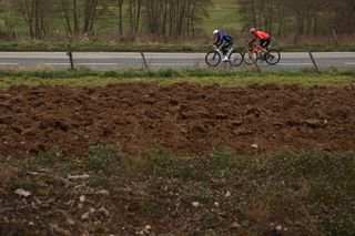 Groupama-FDJ's French rider Thibaud Gruel (L) and Ineos Grenadiers' British rider Ben Swift cycle in a breakaway during the 5th stage of the Paris-Nice cycling race, 196,5 km between Saint-Just-en-Chevalet and La CÃ´te-Saint-AndrÃ©, on March 13, 2025. (Photo by Anne-Christine POUJOULAT / AFP)